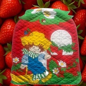 original 1980s design featured on the quilt, Huckleberry Pie has a rag doll